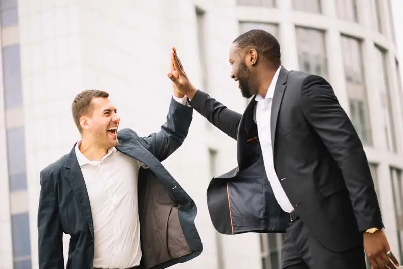 high fiving after channel partner program success