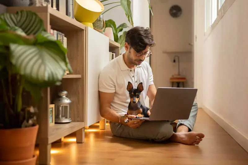 Woman working at home with her pet dog