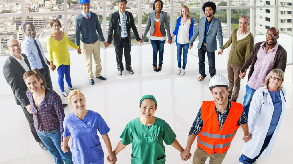 Group of employees holding hands and smiling for National Safety Month
