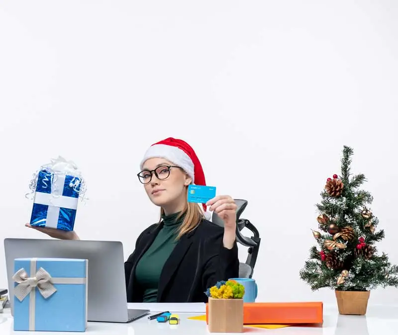 woman with gift card as an employee holiday giving incentive