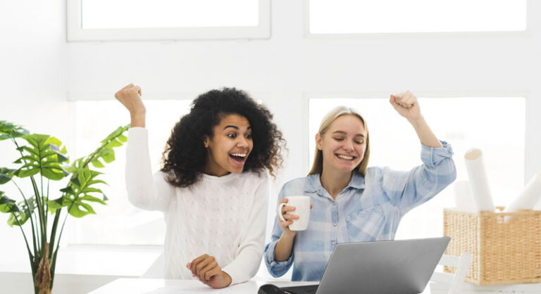 Two woman at work happy about 2026