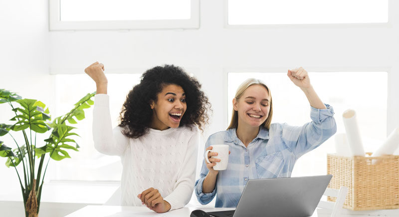 Two woman at work happy about 2026